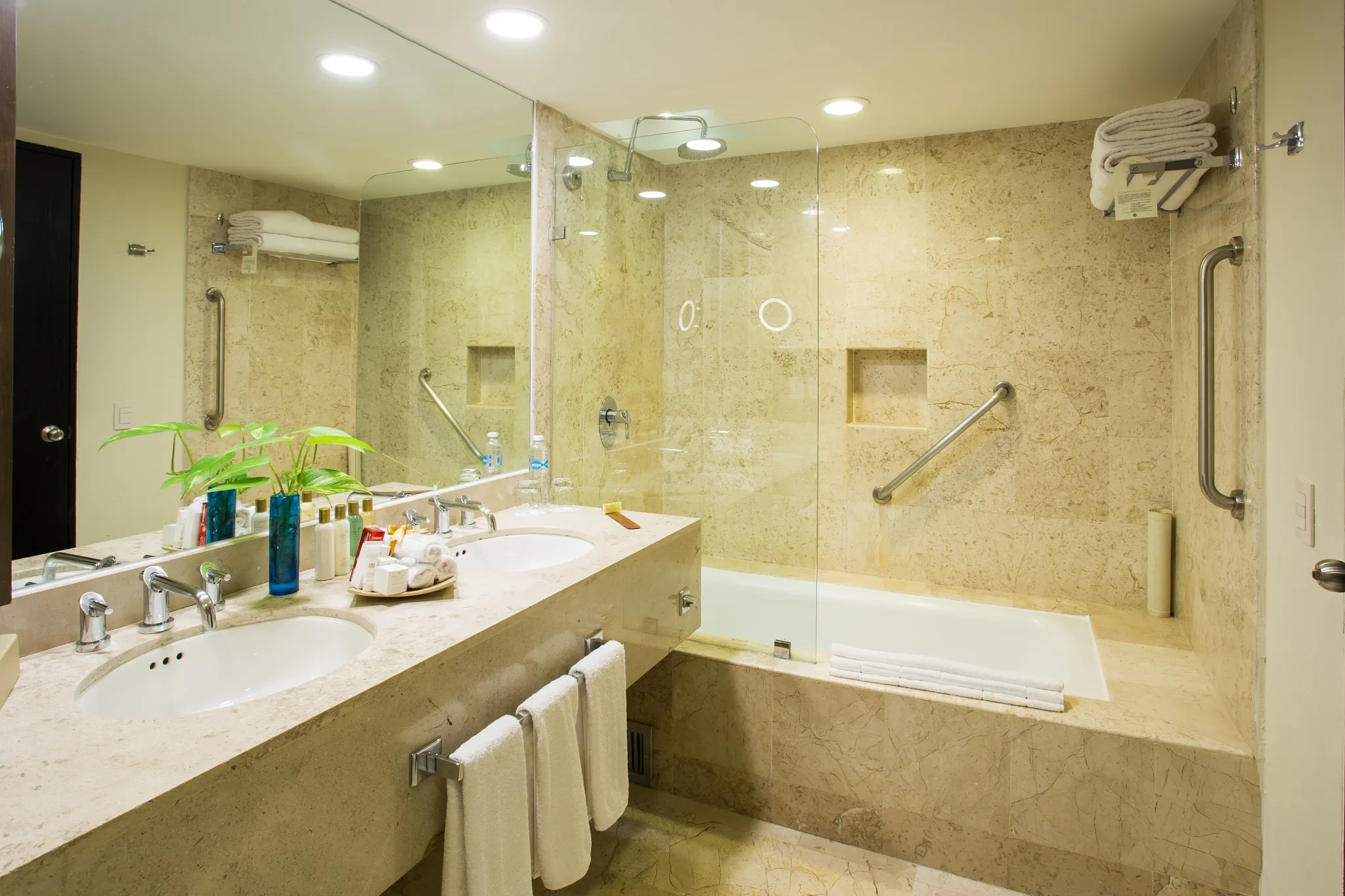 Deluxe Family marble bathroom with bathtub and double sinks at Dreams Sands Cancun Resort & Spa.