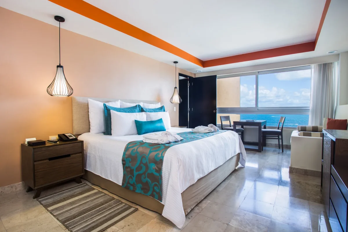 Deluxe Family king bedroom with ocean views at Dreams Sands Cancun Resort & Spa.