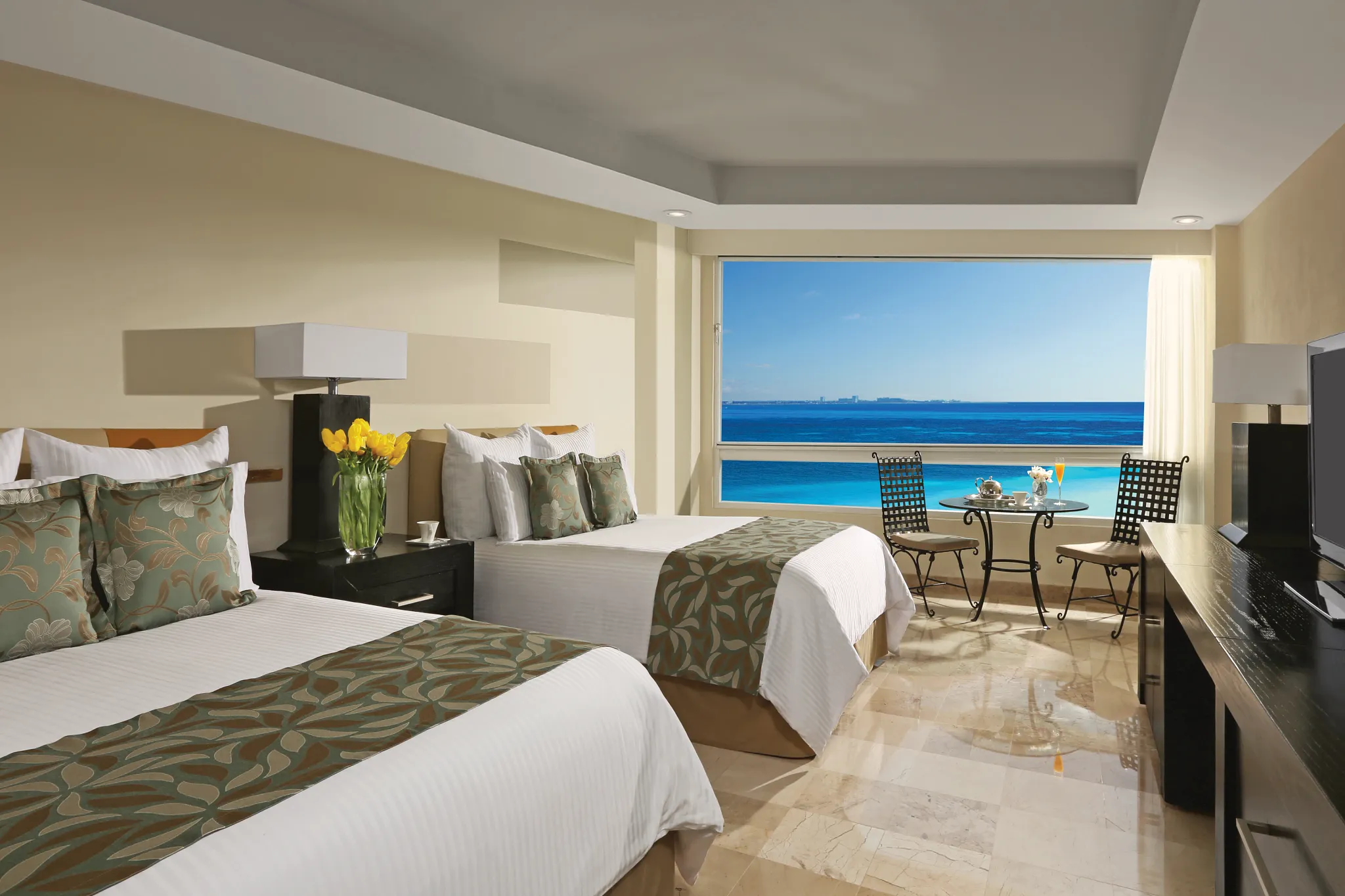 Deluxe Ocean Front room with two double beds and panoramic ocean views at Dreams Sands Cancun Resort & Spa.