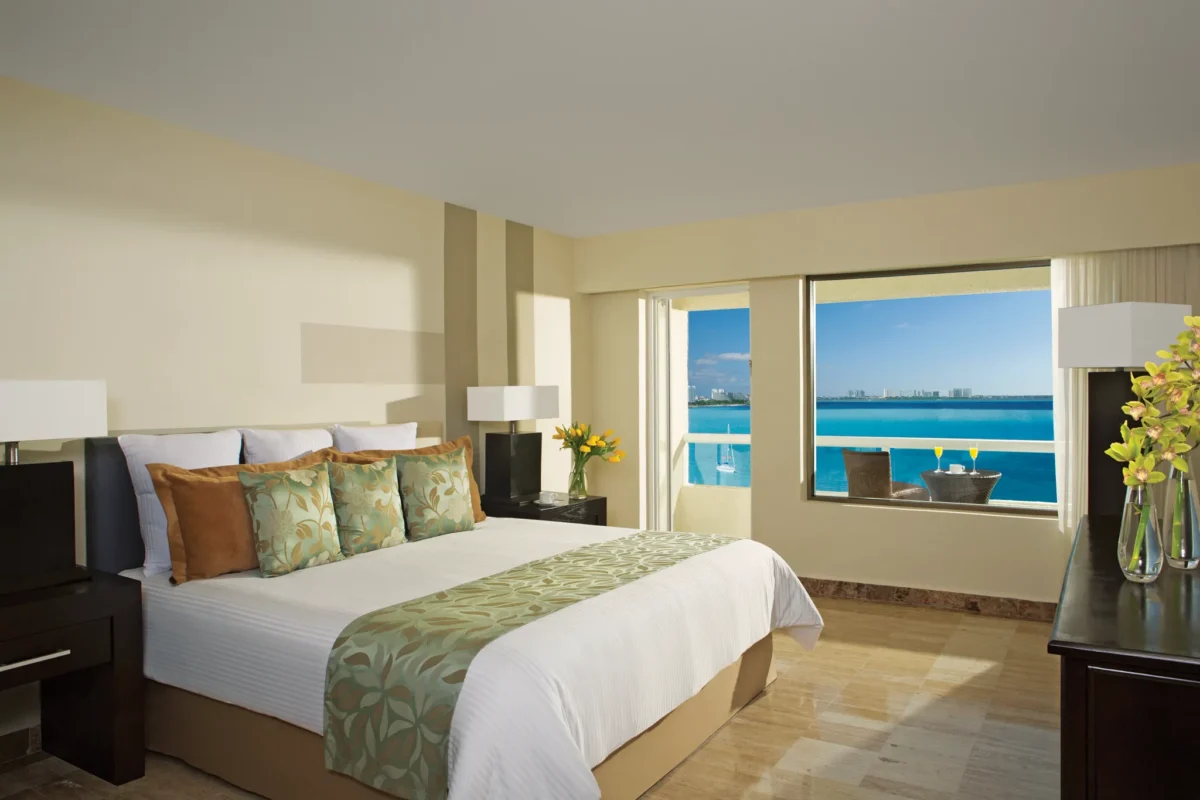 Deluxe Ocean Front king room with private balcony and Caribbean Sea views at Dreams Sands Cancun Resort & Spa.