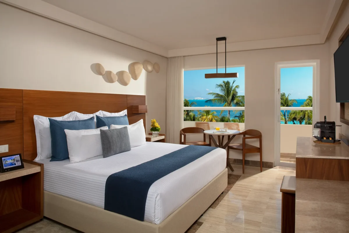 Deluxe Partial Ocean View king room with private balcony at Dreams Sands Cancun Resort & Spa.