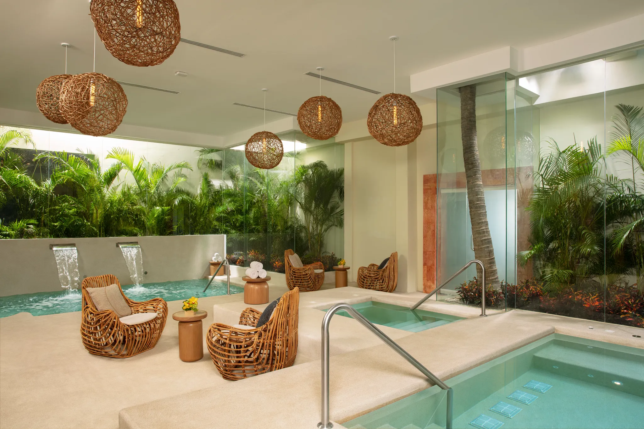 Luxury hydrotherapy spa circuit with plunge pools and tropical decor at Dreams Sands Cancun Resort & Spa.