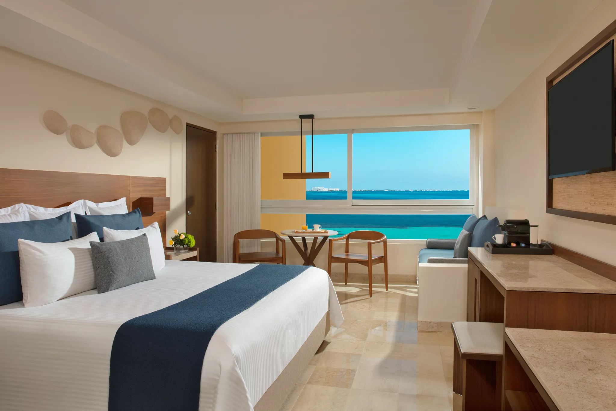 Preferred Club Family Suite king room with oceanfront views at Dreams Sands Cancun Resort & Spa.