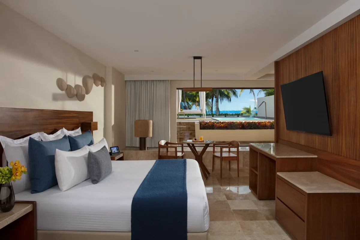 Preferred Club Honeymoon Plunge Pool Suite bedroom with king bed and terrace access at Dreams Sands Cancun Resort & Spa.