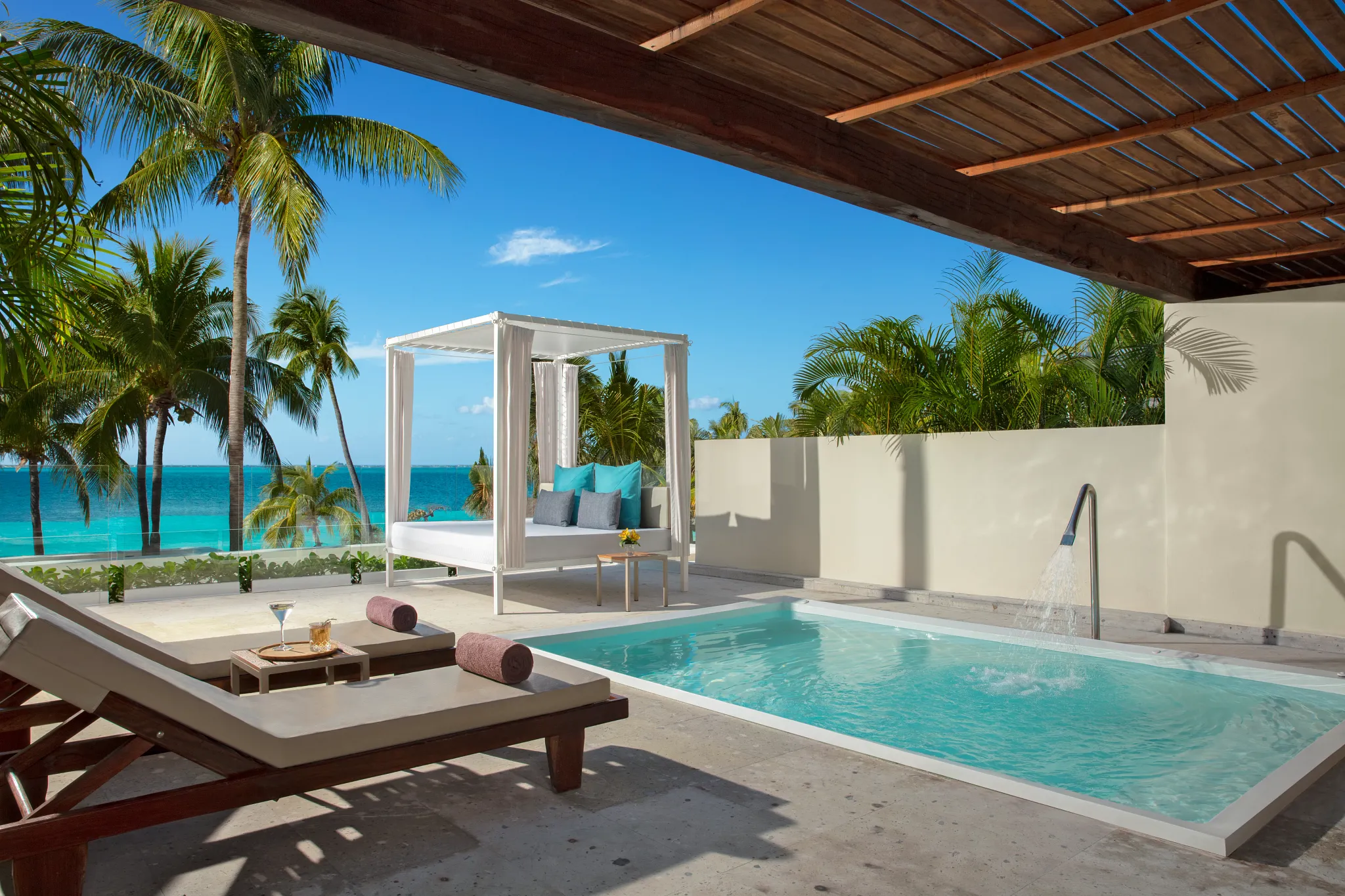 Private terrace with plunge pool and Bali bed at the Preferred Club Honeymoon Plunge Pool Suite in Cancun.