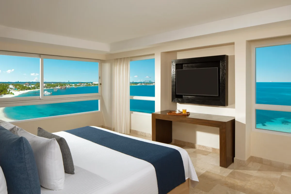 Preferred Club Master Suite king bedroom with panoramic oceanfront views at Dreams Sands Cancun Resort & Spa.