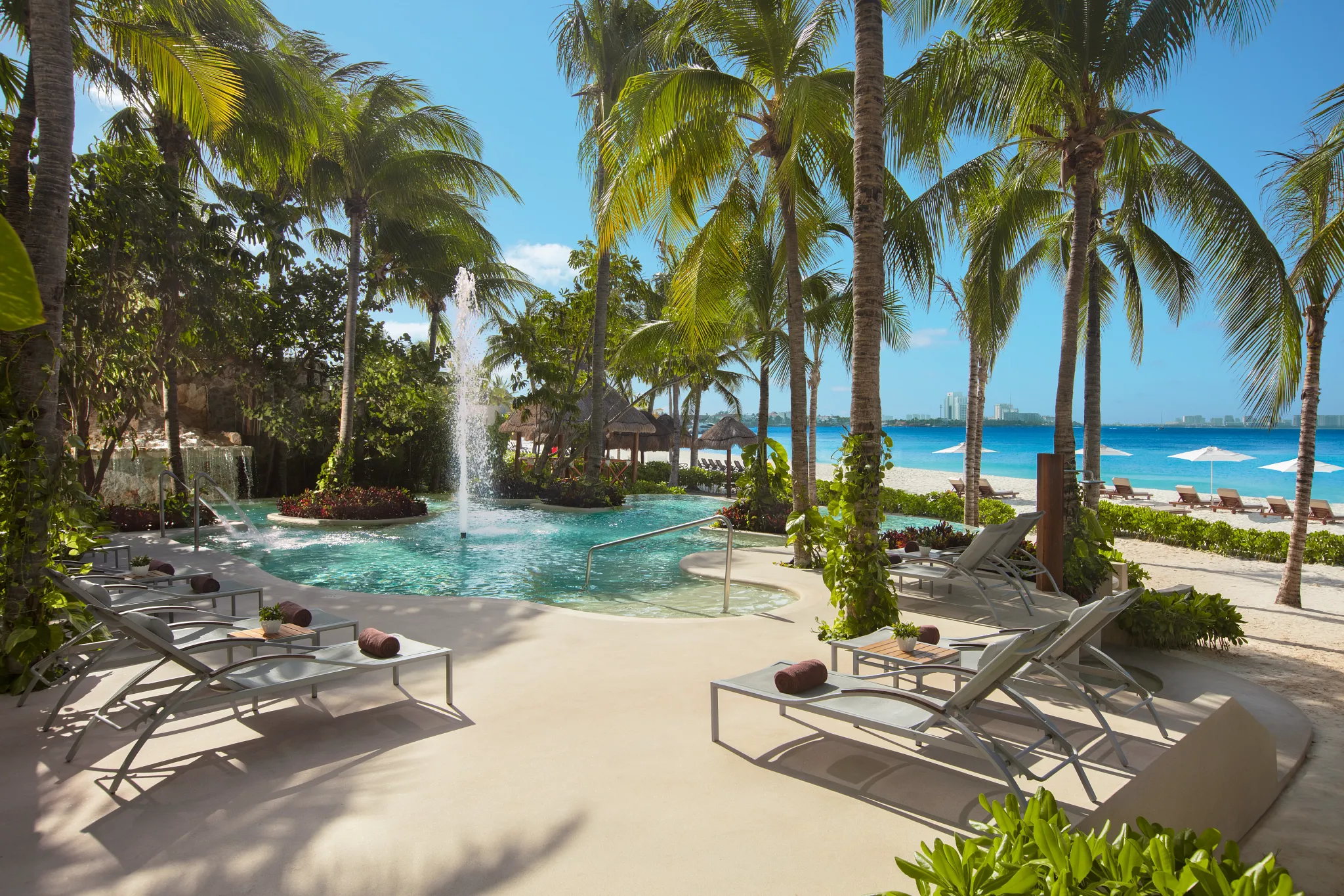Preferred Club Pool Bar at Dreams Sands Cancun Resort & Spa featuring exclusive poolside cocktails, ocean views, and upscale lounge atmosphere.