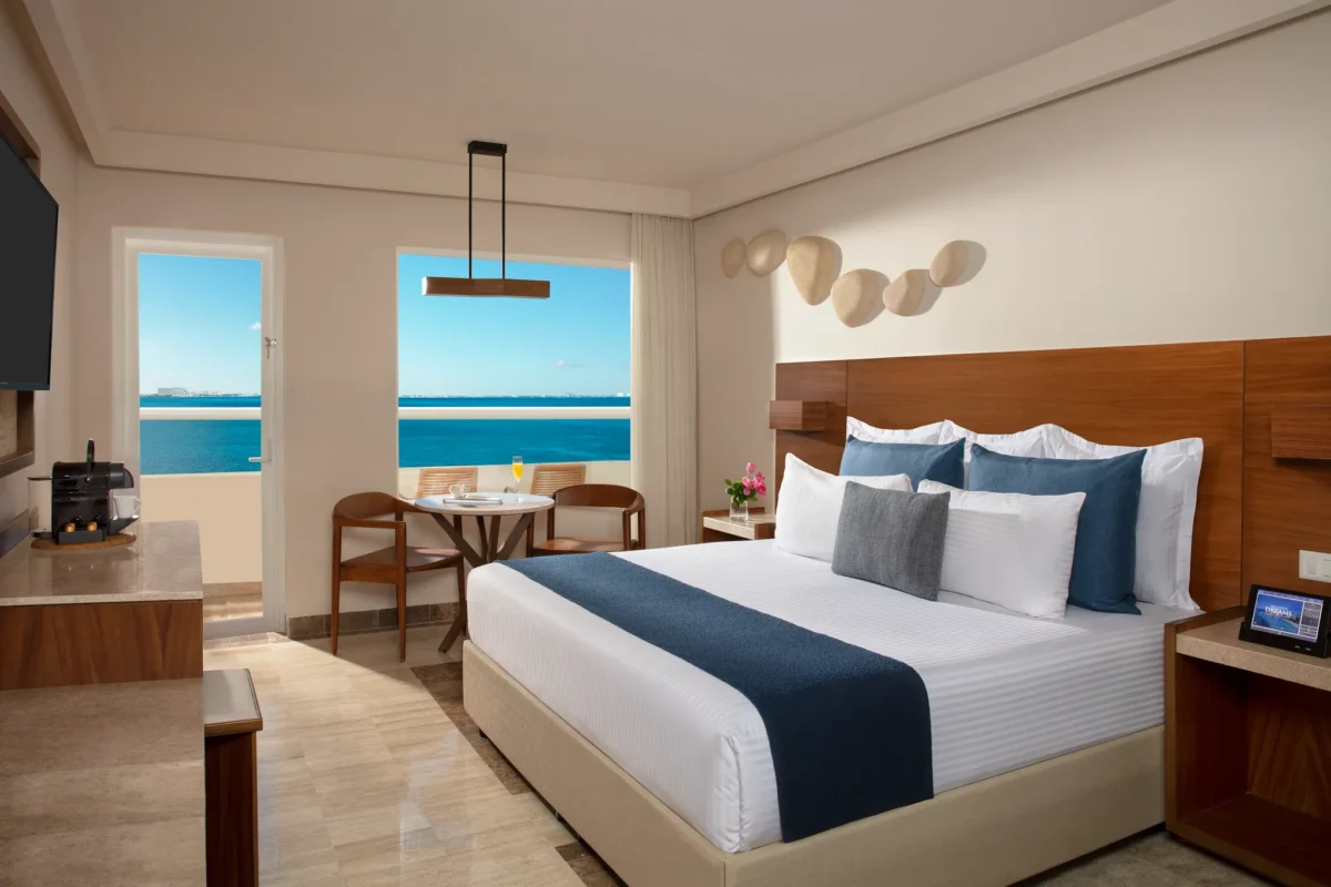 Premium Balcony Ocean Front king room with furnished balcony and Caribbean Sea views at Dreams Sands Cancun Resort & Spa.