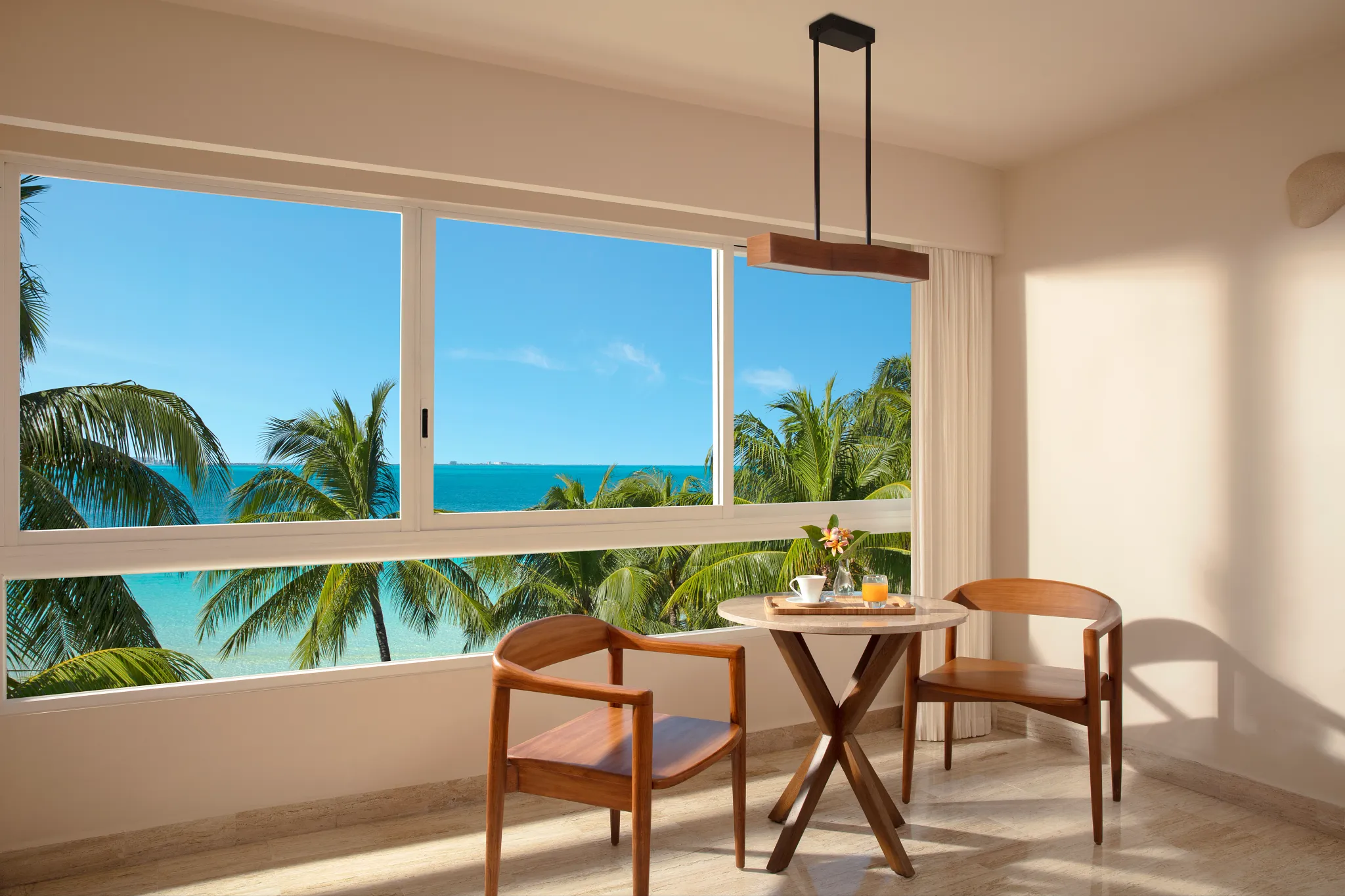Premium Partial Ocean View seating area with panoramic tropical ocean views at Dreams Sands Cancun Resort & Spa.